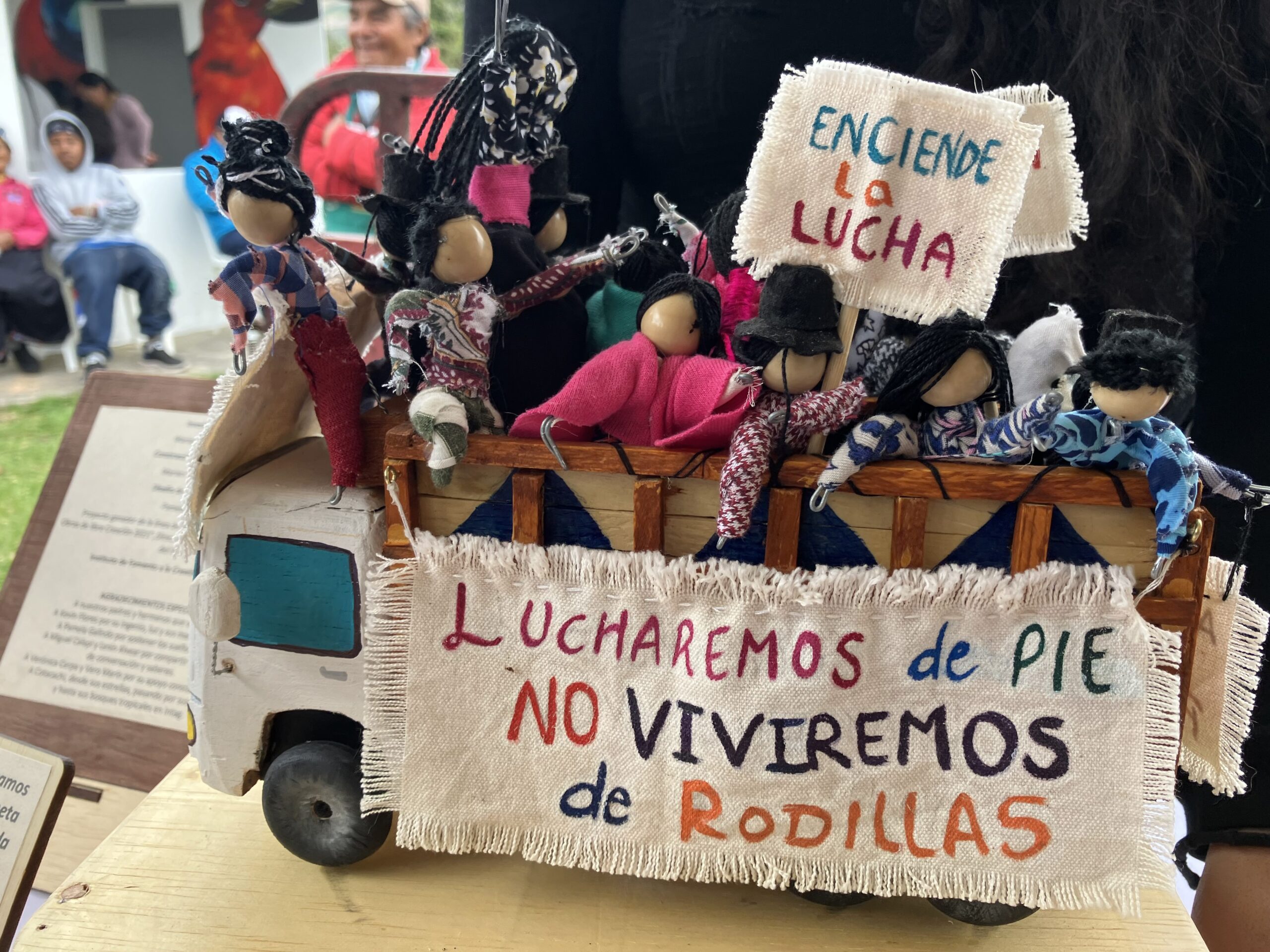 A bunch of soft toys resting on a toy truck. A banner hangs with the words 