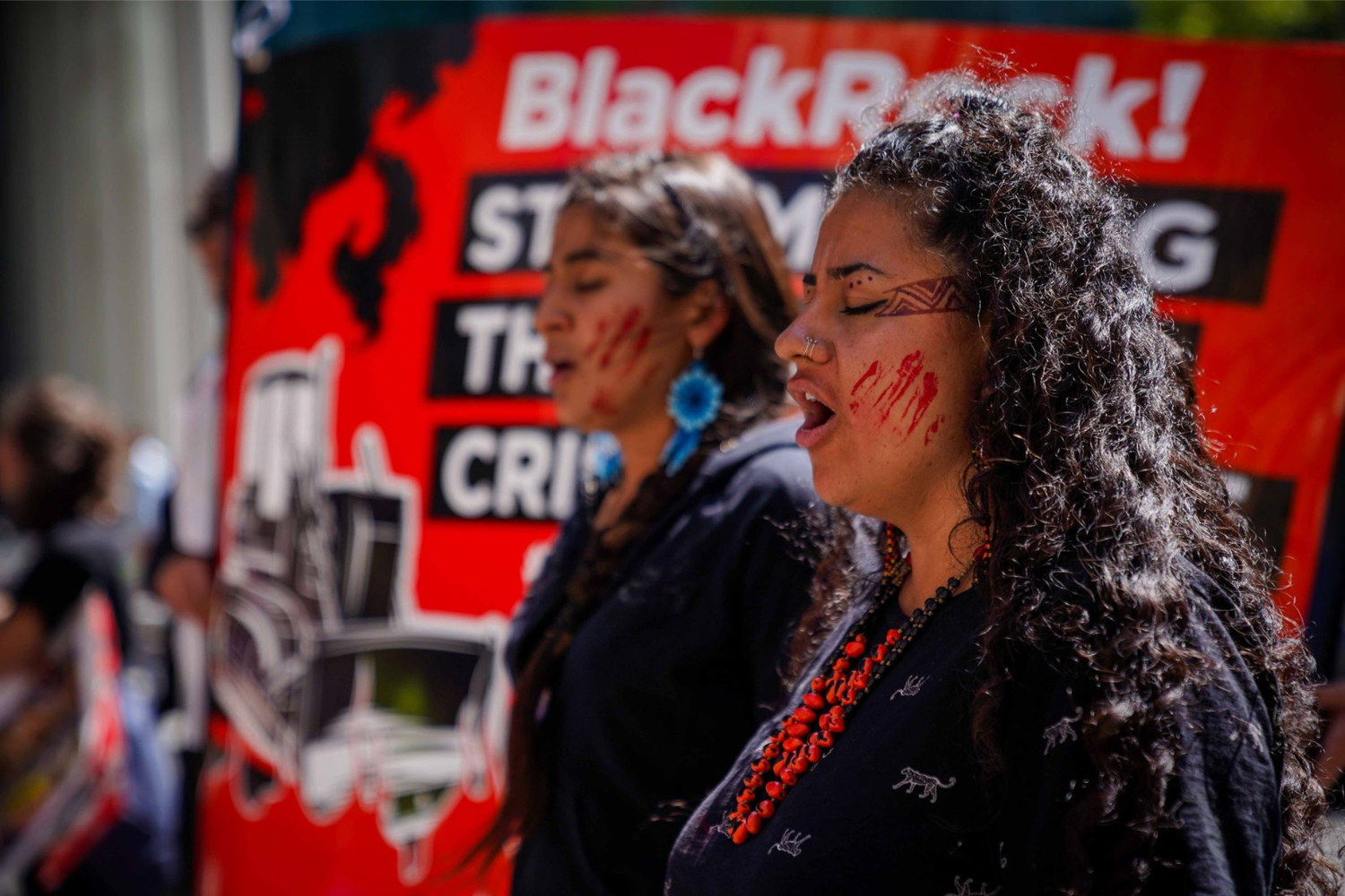 Two women in profile at an Amazon Oil Action rally.